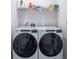 Laundry room featuring a new washer and dryer with storage shelves above at 164 Vineyard Place # 23, Pawleys Island, SC 29585