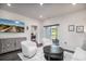 Bright living room features a TV, sliding doors to a screened porch, and an open doorway to a bedroom at 164 Vineyard Place # 23, Pawleys Island, SC 29585
