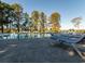 Relaxing pool area with lounge chairs under tall trees, a perfect outdoor oasis at 164 Vineyard Place # 23, Pawleys Island, SC 29585