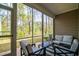 Cozy screened-in porch with outdoor seating and views of the trees at 164 Vineyard Place # 23, Pawleys Island, SC 29585