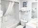 Bright bathroom features a shower-tub combo with crisp white shower curtain, matching sink and toilet, and starfish art at 205 74Th Ave. N # 904, Myrtle Beach, SC 29572