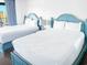 Double beds in a brightly lit bedroom with curtains drawn at 205 74Th Ave. N # 904, Myrtle Beach, SC 29572