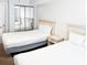 Bright bedroom offers two beds, nightstand, and ample closet space, perfect for a comfortable and organized stay at 205 74Th Ave. N # 904, Myrtle Beach, SC 29572
