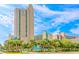 Sand Dunes Resort, a tall, luxurious building, under a partly cloudy bright blue sky at 205 74Th Ave. N # 904, Myrtle Beach, SC 29572