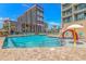Beautiful community pool area with clear blue water, chairs, and an adjacent tower at 205 74Th Ave. N # 904, Myrtle Beach, SC 29572
