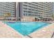 Expansive community pool area with lounge chairs and access to a bar, perfect for relaxation at 205 74Th Ave. N # 904, Myrtle Beach, SC 29572