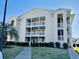 Attractive condo building featuring private balconies, well-kept landscaping, and a clear blue sky at 213 Landing Rd. # F, North Myrtle Beach, SC 29582