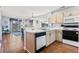 Well-lit kitchen featuring an oven, dishwasher, sink, and an opening to the living and dining areas at 213 Landing Rd. # F, North Myrtle Beach, SC 29582