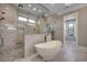 Luxurious bathroom featuring a freestanding tub, glass-enclosed shower, and elegant marble finishes at 2417 Gist Ln., Myrtle Beach, SC 29588