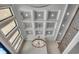 Elegant foyer featuring a coffered ceiling, modern chandelier, and staircase with iron railings at 2417 Gist Ln., Myrtle Beach, SC 29588