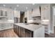 Modern kitchen with marble countertops, white cabinets, stainless steel appliances, and a large island at 2417 Gist Ln., Myrtle Beach, SC 29588