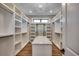 Spacious walk-in closet with custom shelving, center island, and stylish chandelier lighting at 2417 Gist Ln., Myrtle Beach, SC 29588
