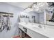 Double vanity sink with tiled walls, hanging towels, and mirrored lighting at 2501 South Ocean Blvd. # 1011, Myrtle Beach, SC 29577