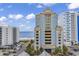 Exterior view of a blue and yellow oceanfront building, showcasing the beachside location at 2501 South Ocean Blvd. # 1011, Myrtle Beach, SC 29577