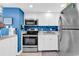 Charming kitchen featuring white cabinets, stainless steel appliances, and blue accents at 2501 South Ocean Blvd. # 1011, Myrtle Beach, SC 29577