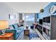 Cozy living room with ocean view through sliding glass doors, featuring a stylish blue sofa at 2501 South Ocean Blvd. # 1011, Myrtle Beach, SC 29577