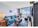 Comfortable living room with ocean view through sliding glass doors, featuring a stylish blue sofa at 2501 South Ocean Blvd. # 1011, Myrtle Beach, SC 29577
