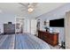 Bright main bedroom featuring a television, wooden floors, and view of the en suite bathroom at 2501 South Ocean Blvd. # 1011, Myrtle Beach, SC 29577