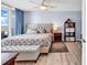 Bright main bedroom features a tufted headboard, balcony access, ceiling fan and wood-look floors at 2501 South Ocean Blvd. # 1011, Myrtle Beach, SC 29577