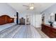 Bright main bedroom featuring a ceiling fan and view of the en suite bathroom at 2501 South Ocean Blvd. # 1011, Myrtle Beach, SC 29577
