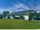 Well-maintained home exterior featuring a large, green lawn, solar panels on the roof, and manicured landscaping at 256 Copper Leaf Dr., Myrtle Beach, SC 29588