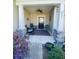 Inviting front porch with rocking chairs, stylish decor, and elegant stone columns with a ceiling fan at 256 Copper Leaf Dr., Myrtle Beach, SC 29588