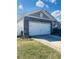 Attached two-car garage with stone accents and a well-maintained lawn and landscaping at 256 Copper Leaf Dr., Myrtle Beach, SC 29588