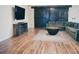 Spacious living room features sliding barn doors, a cozy sofa, and an entertainment center at 256 Copper Leaf Dr., Myrtle Beach, SC 29588