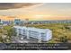 An aerial view of the condo building nestled between the ocean and marsh at 300 Marsh Pl. # 302A, Garden City Beach, SC 29576