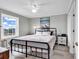 Bedroom featuring neutral walls, a ceiling fan, and a large window with scenic outdoor views at 300 Marsh Pl. # 302A, Garden City Beach, SC 29576