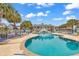Enjoy the spacious community pool surrounded by lounge chairs, perfect for a relaxing day at 300 Marsh Pl. # 302A, Garden City Beach, SC 29576