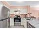 Modern kitchen features stainless steel appliances and marble countertops at 300 Marsh Pl. # 302A, Garden City Beach, SC 29576