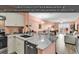 Open concept kitchen features stainless steel appliances and marble countertops at 300 Marsh Pl. # 302A, Garden City Beach, SC 29576
