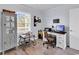 Home office features a wooden desk, comfortable chair, neutral colored walls, and a large window at 300 Marsh Pl. # 302A, Garden City Beach, SC 29576