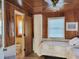 Bedroom with paneled walls connected to private bathroom and natural light, creating a calm retreat at 312 Norris Dr., Pawleys Island, SC 29585