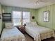 Sunlit bedroom with twin beds, paneled walls, and a window offering natural light at 312 Norris Dr., Pawleys Island, SC 29585