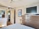 Bedroom area features hardwood floors, TV over dresser, and ensuite bath at 312 Norris Dr., Pawleys Island, SC 29585