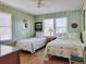 Inviting bedroom showcases paneled walls, two beds, and natural light from the window at 312 Norris Dr., Pawleys Island, SC 29585