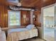 Cozy bedroom with wood paneling, natural light, and twin beds, offering a warm and inviting atmosphere at 312 Norris Dr., Pawleys Island, SC 29585