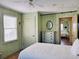 This charming bedroom features paneled walls, a ceiling fan and a doorway leading to another bedroom at 312 Norris Dr., Pawleys Island, SC 29585