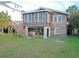 A charming multi-level home featuring wood siding, a spacious yard, and convenient covered parking at 312 Norris Dr., Pawleys Island, SC 29585