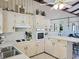 Well-lit kitchen featuring a classic design with white cabinetry, built-in oven and cooktop, and ample counter space at 312 Norris Dr., Pawleys Island, SC 29585