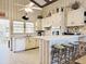 Cozy kitchen with bar, white cabinetry, and view to exterior at 312 Norris Dr., Pawleys Island, SC 29585