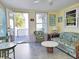 Cozy living room featuring wood paneling, tile floors, comfortable seating, and access to a covered patio area at 312 Norris Dr., Pawleys Island, SC 29585