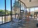 Inviting screened porch with rocking chairs overlooking tropical scenery at 312 Norris Dr., Pawleys Island, SC 29585