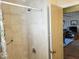 Well-lit shower stall featuring neutral tile and chrome fixtures, next to an open doorway at 312 Norris Dr., Pawleys Island, SC 29585