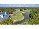 Beautiful golf course aerial featuring pristine green, water feature, and adjacent building with a blue roof at 366 Pinehurst Ln. # 13E, Pawleys Island, SC 29585