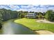 Stunning view of golf course with waterfront, clubhouse, and players enjoying a round in a picturesque setting at 366 Pinehurst Ln. # 13E, Pawleys Island, SC 29585