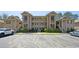 Condo complex with well-maintained parking area, surrounded by lush greenery at 366 Pinehurst Ln. # 13E, Pawleys Island, SC 29585