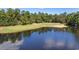 Scenic view of golf course and lake surrounded by mature trees at 366 Pinehurst Ln. # 13E, Pawleys Island, SC 29585